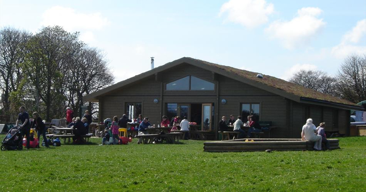 people sat eating and drinking outside Broom House Farm Coffee shop